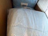 a cat that is laying on a pillow in a box