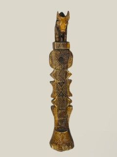 a wooden sculpture of a horse on a pole