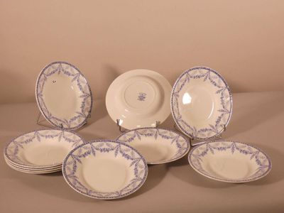 six blue and white china plates and a bowl on a table