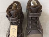 brown leather boots with fur lining and a tag on the side of them