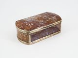 an image of a silver and brown box on a white surface
