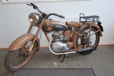 a brown motorcycle parked in front of a window
