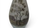 a vase that has a picture of trees on it
