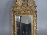 a mirror that is sitting on a table in front of a wall