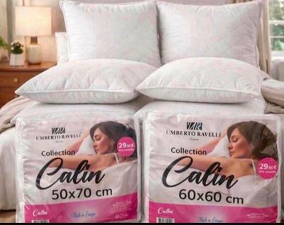 two pillows on a bed in a bedroom next to each other
