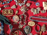 a red case filled with assorted jewelry and other items