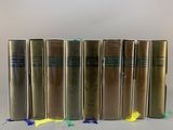 six books are lined up in a row on a table