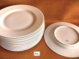 several white plates stacked on top of each other on a table