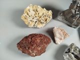 several different types of rocks on a table with a white background
