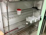 a shelf with pots and pans on it in a kitchen