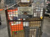 a metal cart with many items in it in a warehouse