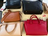 a lot of purses that are on a table