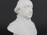 a white busturine of a man on a black background