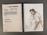 an open book with a drawing of a man holding a baseball bat