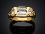 an 18k yellow gold ring with baguets and diamonds