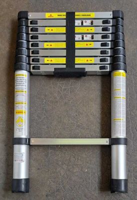 a close up of a ladder on the ground with a pair of handles