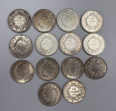 a group of silver coins on a white surface