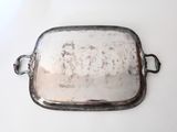 a silver tray with a handle on a white table