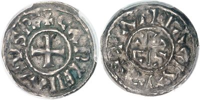 a close up of two silver coins on a white surface