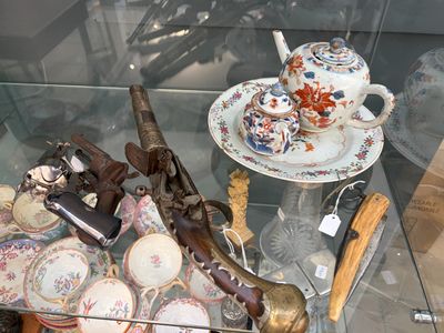 une table en verre avec une vitrine en verre remplie d'objets anciens