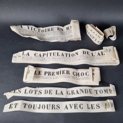 four pieces of old newspaper on a table with a broken piece of paper