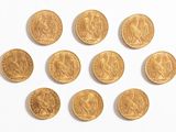 six souverains d'or sont disposés en cercle sur une surface blanche