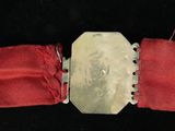 an image of a red belt with a silver buckle on it