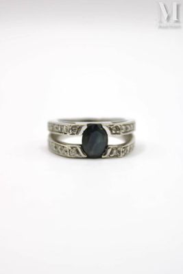 a close up of a ring with a black stone on it