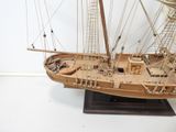 a wooden model of a boat on display on a table