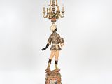 an image of a figurine of a man with a chandelier on his head