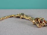 a close up of a lizard broochle on a table