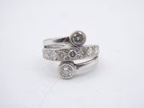 a close up of a silver ring with two diamonds on it
