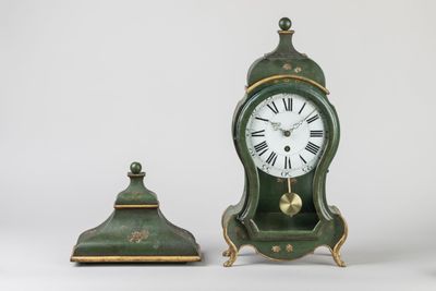 a small green clock sitting next to a smaller green clock