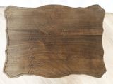 a wooden tray with a design on it on the floor