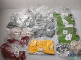 many different types of clothing wrapped in plastic bags