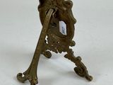 a small bronze figurine of a man holding a baseball bat