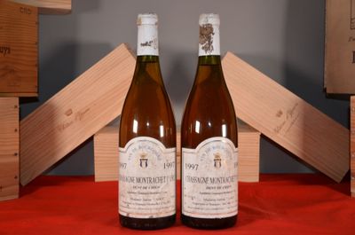 two bottles of wine sitting on a table next to each other