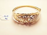 a close up of a gold ring with diamonds on a white surface