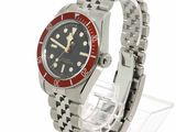 an image of a wrist watch with a red bezeled dial