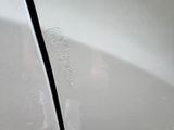 a close up of a car ' s front bumper with scratches on it