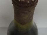 a small vase with a face on it on a table