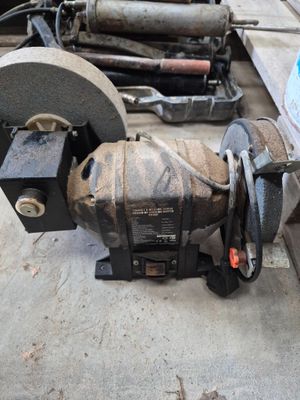 a machine that is sitting on the ground next to some tools