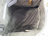 a white purse that is open on the table