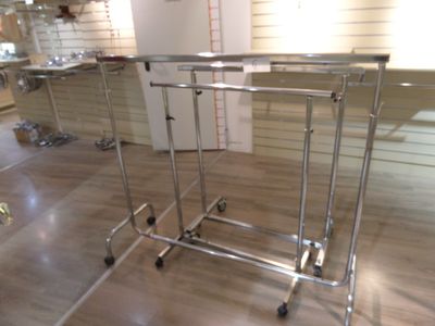 two tables that are sitting on wheels in a room