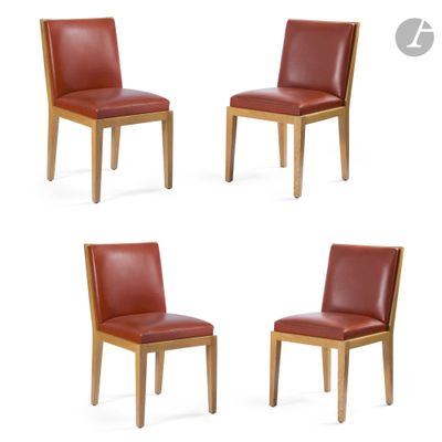 four red leather dining chairs with wooden legs on a white background