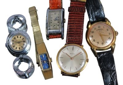 many different types of watches on display on a white surface