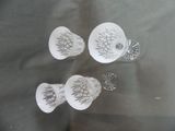 four glass cups and a spoon on a table
