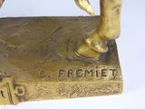 a gold statue of a person on a horse
