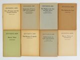 six books are stacked on top of each other on a white surface