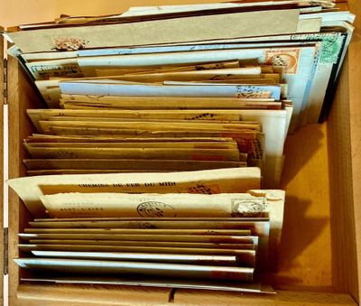 une boîte remplie de vieilles lettres et d'enveloppes posée sur une table